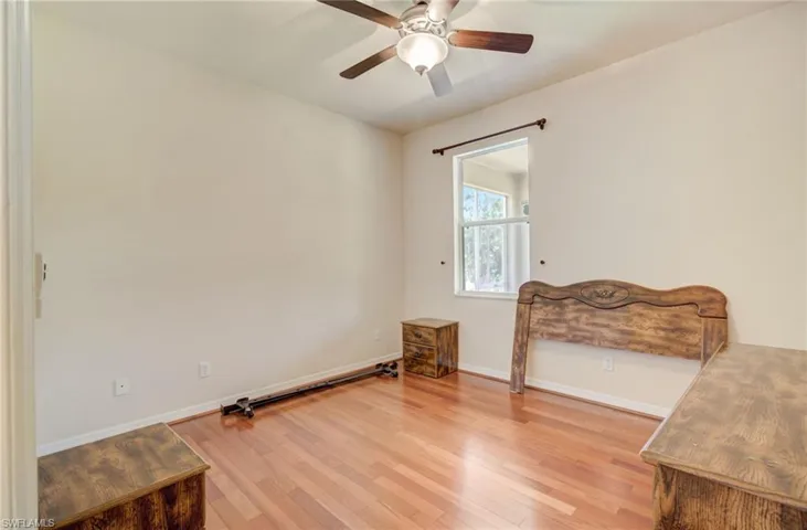 Bedroom featuring hardwood / wood-style floors and ceiling fan