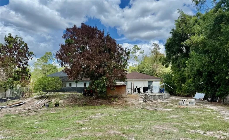 Back of property featuring a patio and a yard