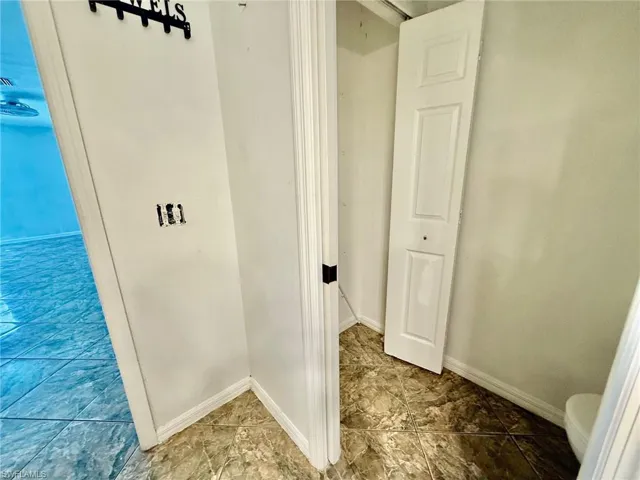 Walk in closet with marble finish flooring