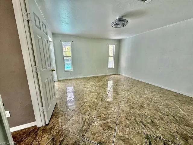 Unfurnished room with vaulted ceiling and a ceiling fan