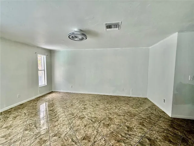 Unfurnished bedroom featuring a closet and baseboards