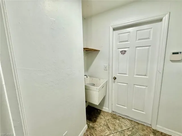 Laundry area featuring hookup for a washing machine and cabinet space