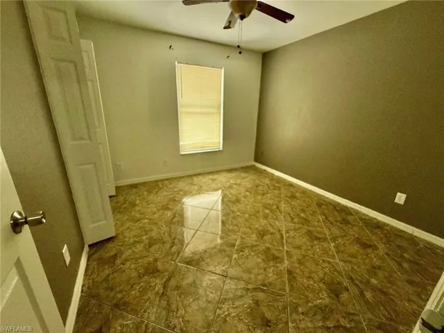 Spare room featuring baseboards