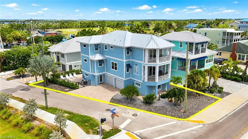 Coastal property with direct street frontage, featuring a two-story structure with a covered patio - Virtually Edited Image