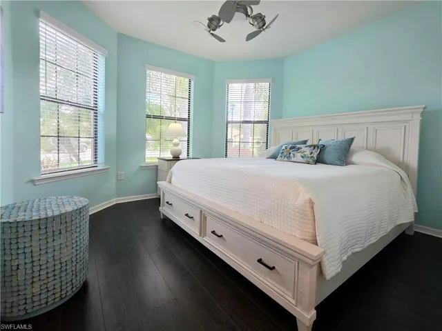 Bedroom featuring dark wood-style flooring and ceiling fan