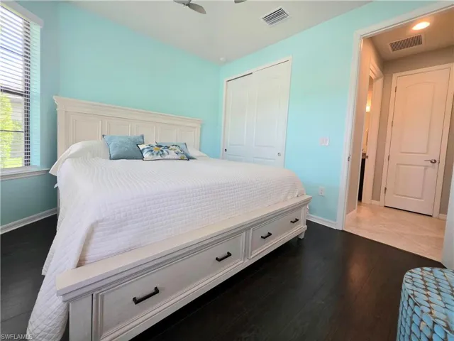 Bedroom featuring a closet and dark wood-type flooring