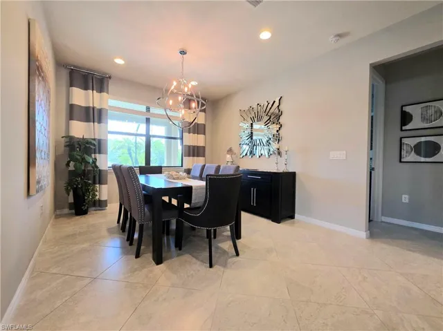 Dining space featuring suspended lighting and baseboards