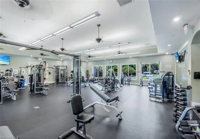 Workout area featuring a ceiling fan and recessed lighting