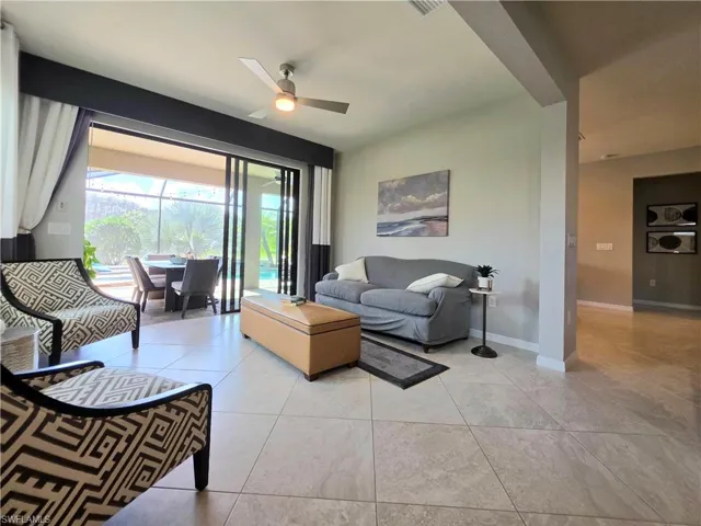 Extended Living room with ceiling fan and baseboards