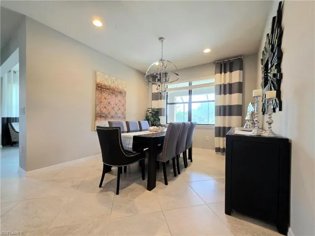 Dining room featuring suspended lighting and light tile patterned floors