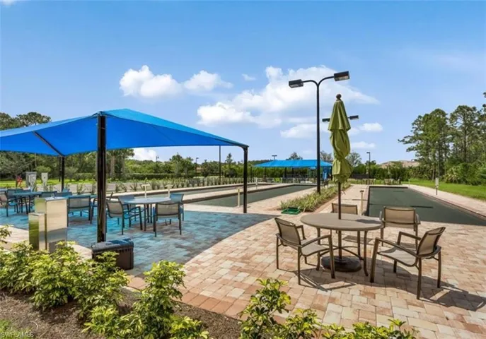 Surrounding community featuring a game area, a patio area, and a mountain view