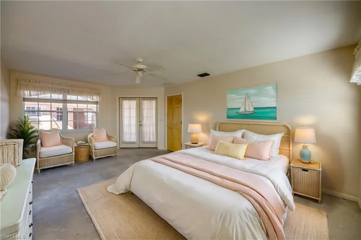 Virtually staged. Primary Suite is spacious enough for a sitting area and features a huge walk-in closet and an en-suite bathroom. Offers windows to the canal and to the huge courtyard and french doors to the courtyard.