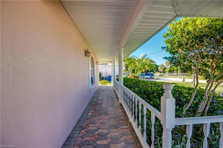 Lovely Front porch with brick pavers. Perfect place for your Rocking chairs to sit and watch the gorgeous SW FL Sunsets while sipping your favorite beverage!