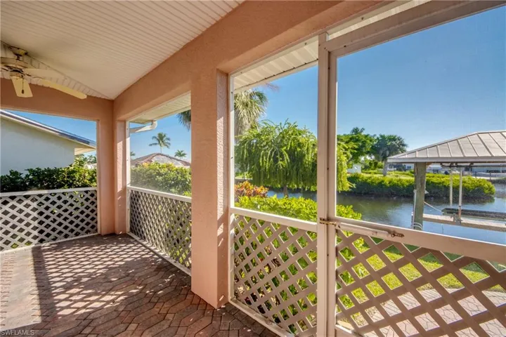 Lanai in the back of home features brick pavers and is under truss and screened. Back screened door leads to brick pavered walkway and on to the Dock and boat lift!