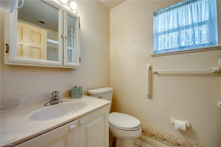 Guest bathroom located in hallway across from the guest bedroom. Features walk-in shower and window.
