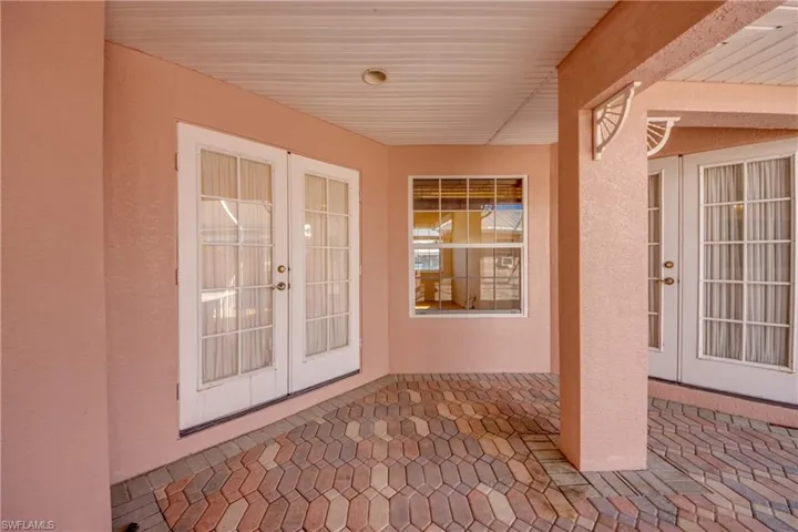 Covered area of the huge Private courtyard features French Doors to the left that enter the Breakfast Nook are and French door to the right that enter the Great room.