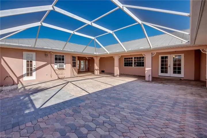 Huge Private Brick paver Courtyard with covered and open screened sitting areas! Offers entry to the Cabana Guest Suite and the main home! So many possibilities for this lovely area!
