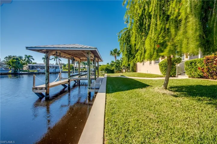 Backyard view of seawall and dock with lift.