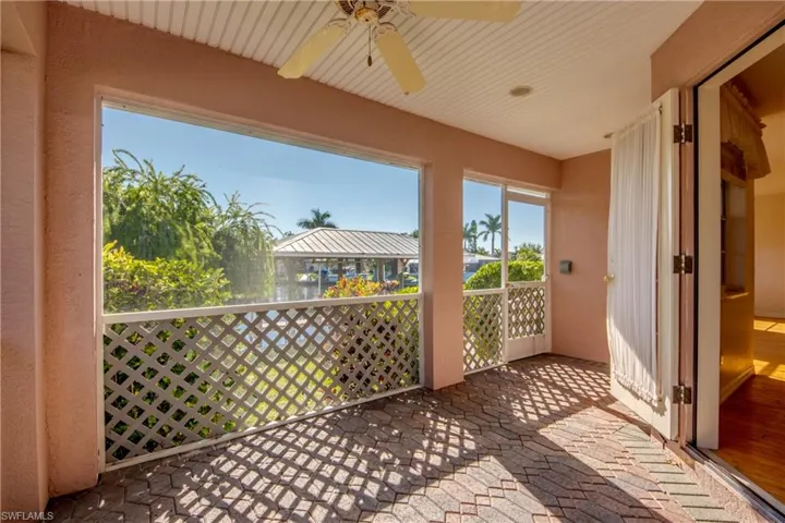 Lanai in the back of home features brick pavers and is under truss and screened. Back screened door leads to brick pavered walkway and on to the Dock and boat lift!