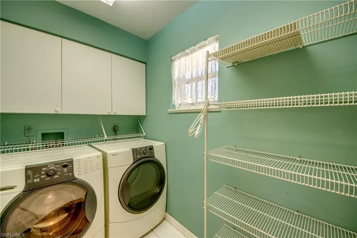 Laundry room located off of the kitchen offers pantry space.