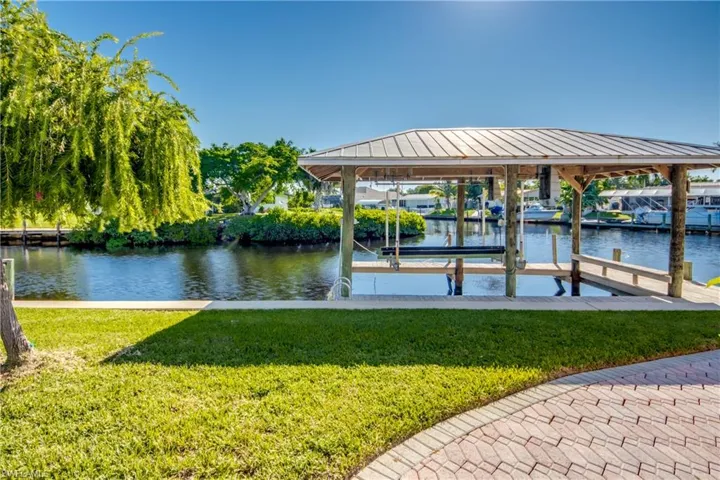 Wrap around dock with metal roof covered boat lift and view of intersecting canals. Located on the main canal in the community and only 9 homes from the Caloosahatchee Intracoastal Waterway and on to the Gulf!