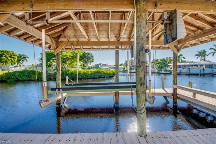 Wrap around dock with metal roof covered boat lift. Quick Direct Gulf access via main canal to the  Caloosahatchee Intracoastal Waterway and on to the Gulf!