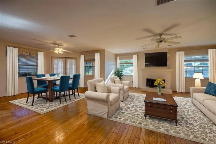 Large Great room Virtually staged. Features 8 windows for a light filled room and views to the Waterway and to the Private Courtyard. French doors to the left open to the Covered and screened Lanai which offers views of the intersecting canal and leads to the boat dock and lift. A second set of French doors lead to the Private Courtyard.