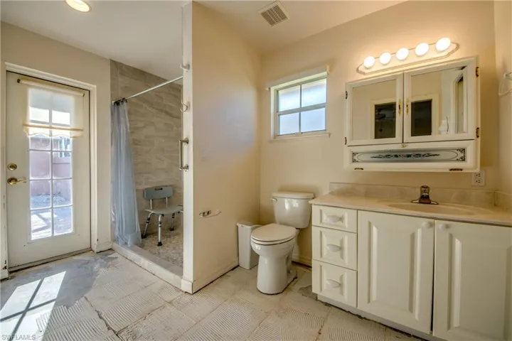 Guest Cabana Bathroom with French door to Courtyard and walk-in shower.