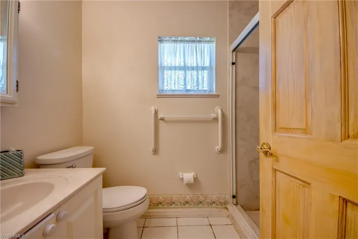 Guest bathroom located in hallway across from the guest bedroom. Features walk-in shower and window.