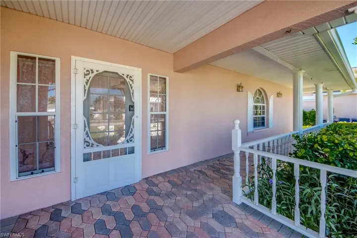 Lovely Front entry porch with brick pavers. Leads to the Huge Screened Private Courtyard entry!