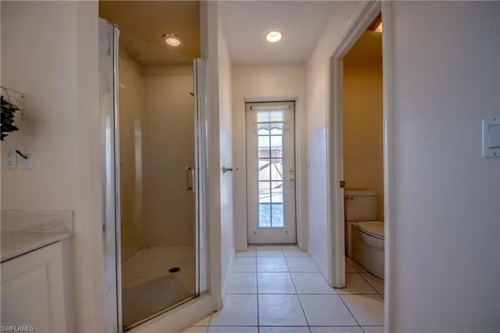 Primary en-suite bathroom is spacious and features double sinks and a large vanity, Soaking tub, linen closet, separate water closet and a walk-in shower. There is French door leading to the Private courtyard .