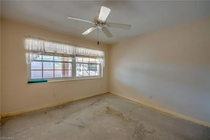 Guest bedroom with window view of private courtyard.
