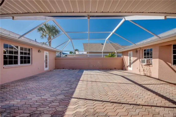 Huge Private Brick paver Courtyard with covered and open screened sitting areas! Offers entry to the Cabana Guest Suite and the main home!So many possibilities for this lovely area!