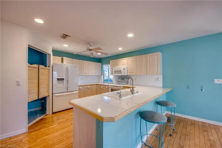 Kitchen is open to the breakfast nook and features a serving window to the covered and screened Lanai. There is a Laundry room off the kitchen that has ample space for a pantry.