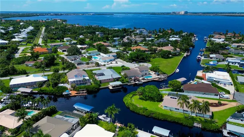 LOCATION, LOCATION, LOCATION! Great opportunity to own a Quick Direct Gulf Access Home in the Popular Iona McGregor Area! Main Canal Frontage and Intersecting Canal Views! Quite Cul-de-sac Street and only 9 Homes to the River! Courtyard Style home built in 1996 with a Metal roof & 2,020 Sq Ft of Living area.  Brick Paver Walkway leading to the Large walk around Dock with a Covered Boat Lift.  Boating access to wonderful waterfront restaurants, barrier islands for shelling or go Dolphin & Manatee watching!