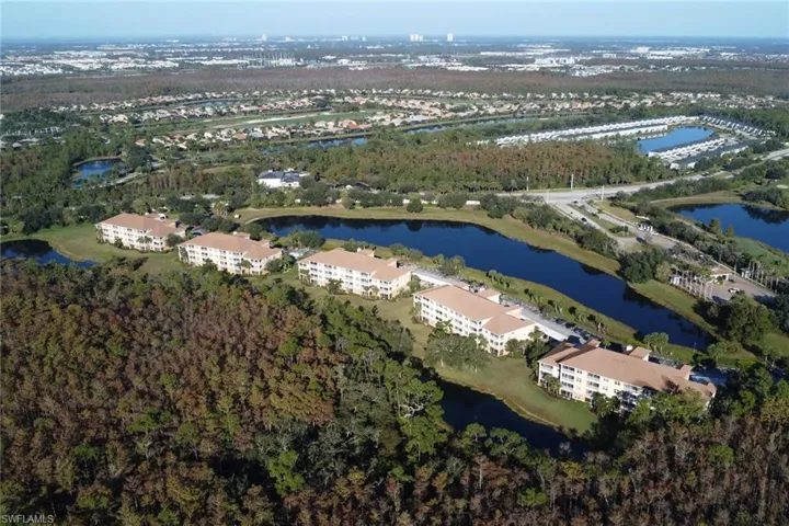 Aerial view of property's location with a large body of water and apartment complex