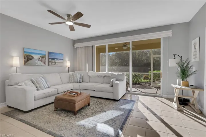 Living area with baseboards and light tile patterned floors