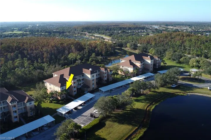 Drone / aerial view of a nearby body of water and apartment complex