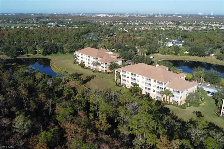 View of property location with apartment complex and a large body of water