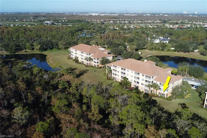 Aerial overview of property's location featuring apartment complex and a nearby body of water