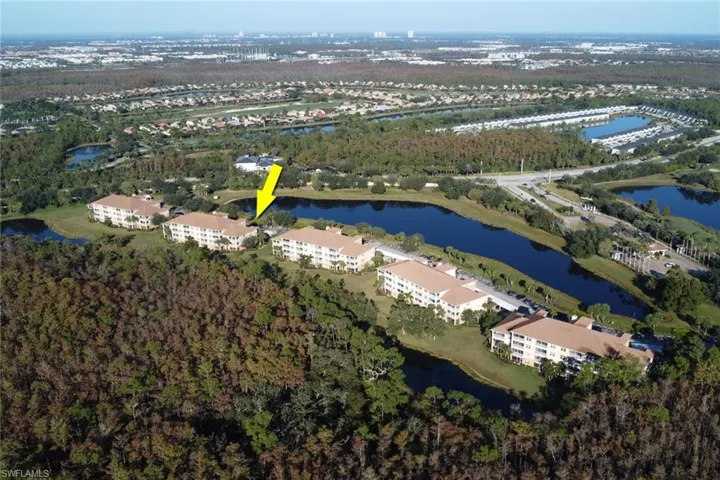 View of property location featuring a large body of water and apartment complex