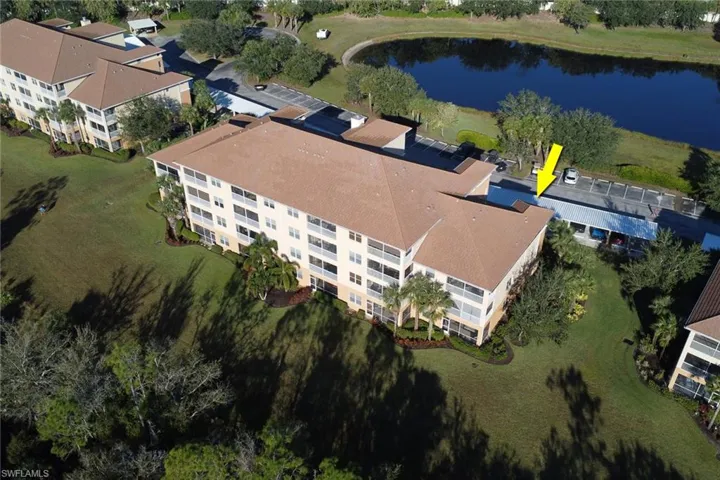 Drone / aerial view of apartment complex and a nearby body of water