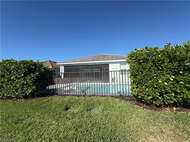 Screened pool enclosure with a black metal safety fence