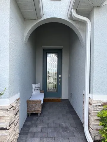 Arched entryway featuring a decorative glass paneled door