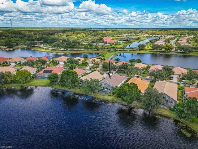 Aerial overview of property's location with a large body of water and nearby suburban area