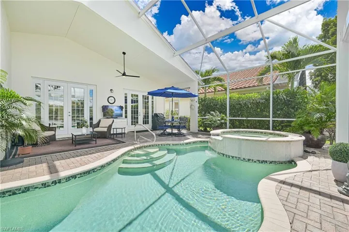 View of swimming pool featuring french doors, a patio area, and a ceiling fan