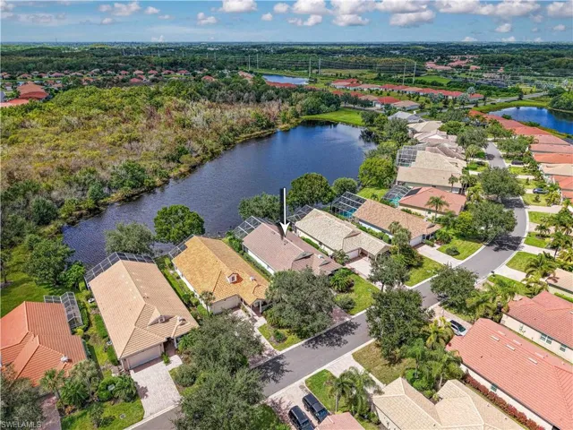 Aerial perspective of suburban area featuring a large body of water