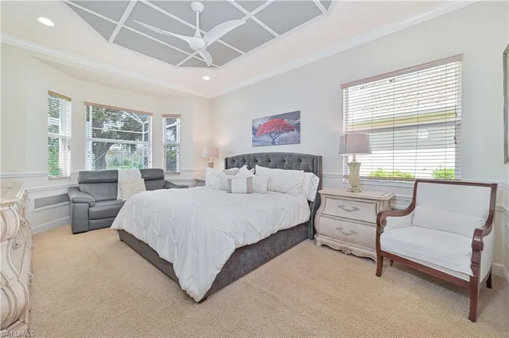 Carpeted bedroom featuring recessed lighting, crown molding, and coffered ceiling