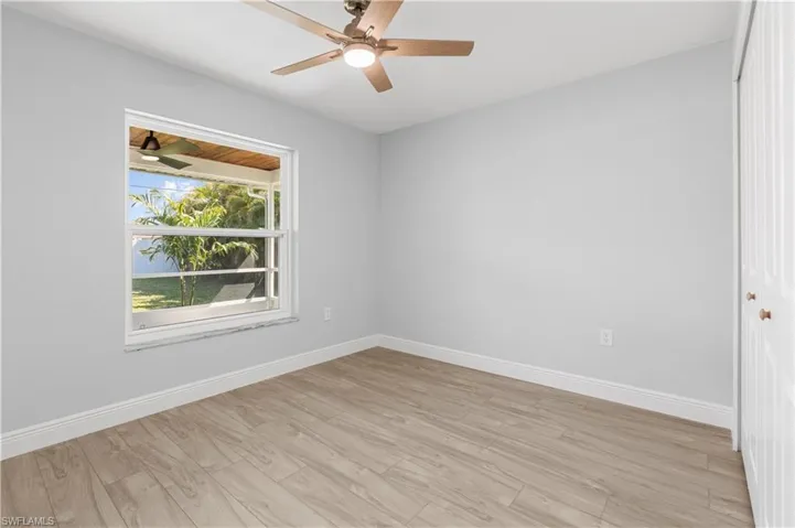 Spare room with ceiling fan and light hardwood / wood-style flooring