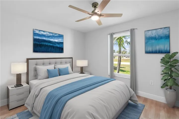 Bedroom featuring ceiling fan and light wood-type flooring